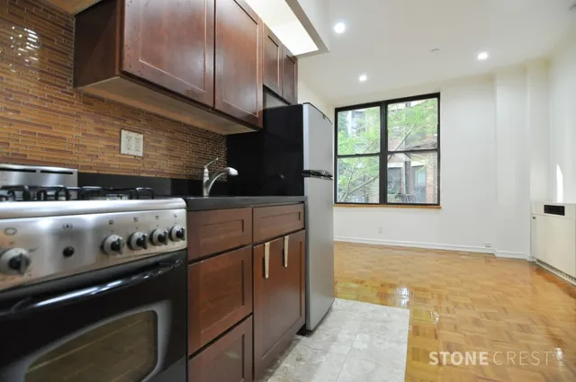 a kitchen with stainless steel appliances granite countertop a stove and a microwave