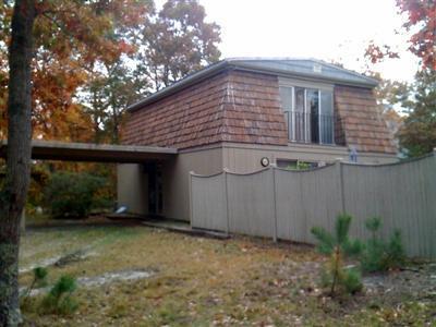 9 Spoondrift Circle Mashpee, MA 02649 - Photo 2 of 21 a front view of a house with a yard