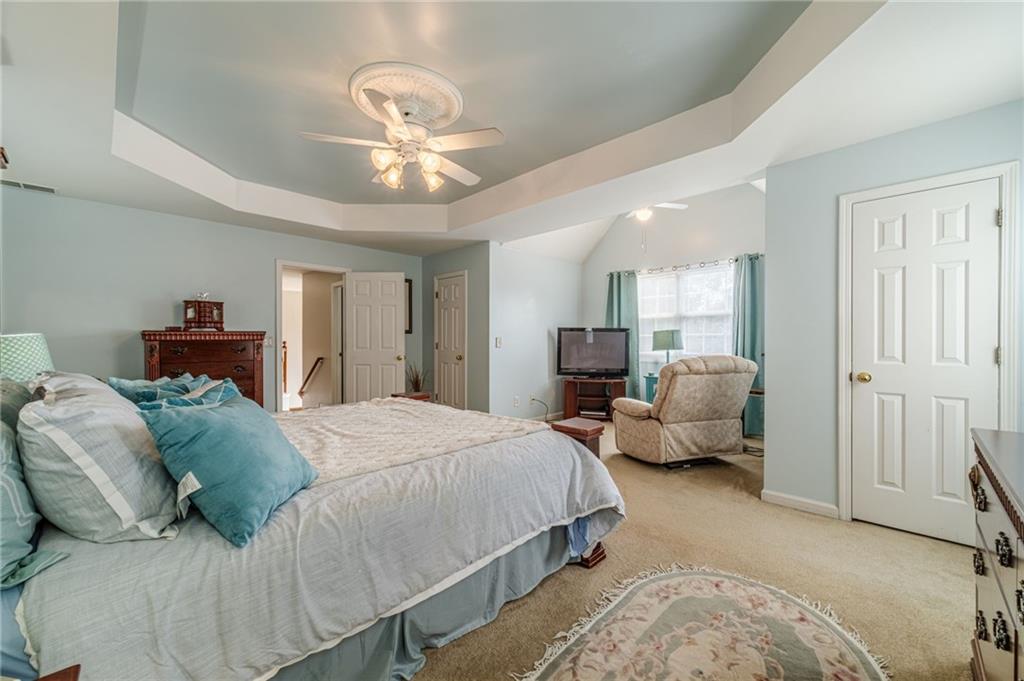 3442 Flat Run Drive Southeast Bethlehem, GA 30620 - Photo 27 of 47 a spacious bedroom with a bed and a chandelier