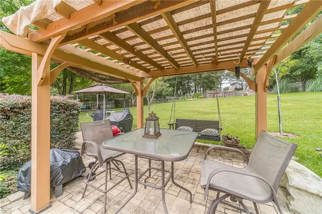 a view of a trees and barn in the middle of a field