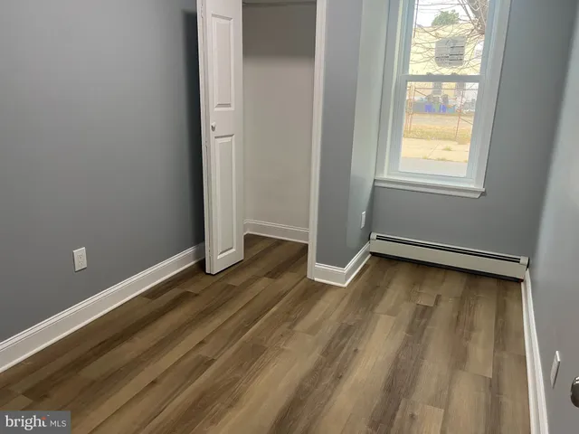 a view of a room with wooden floor and window
