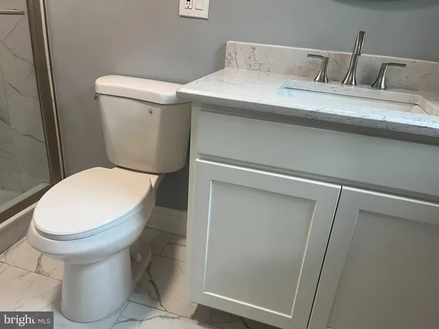 a white toilet sitting next to a bathroom sink
