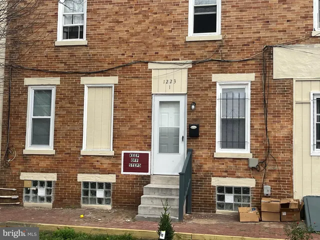 a front view of a building with a brick wall