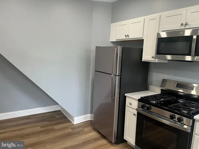 a kitchen with a refrigerator stove and microwave