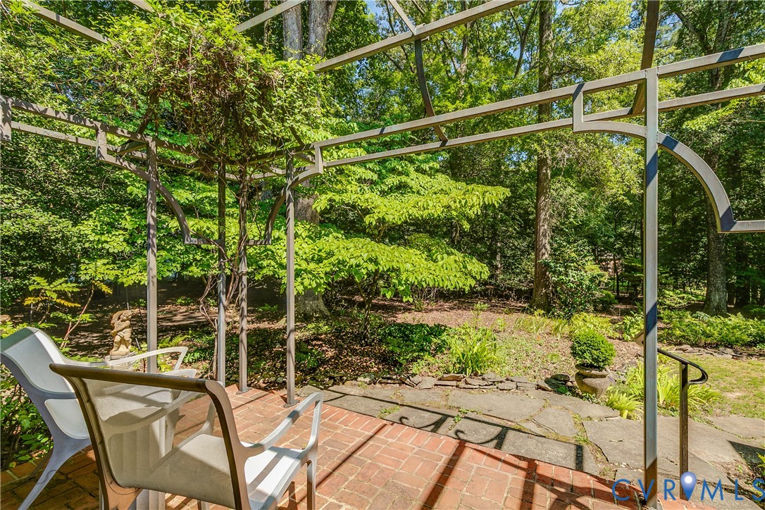 10475 Cherokee Road Richmond, VA 23235 - Photo 51 of 74 Brick patio with a metal pergola featuring climbin