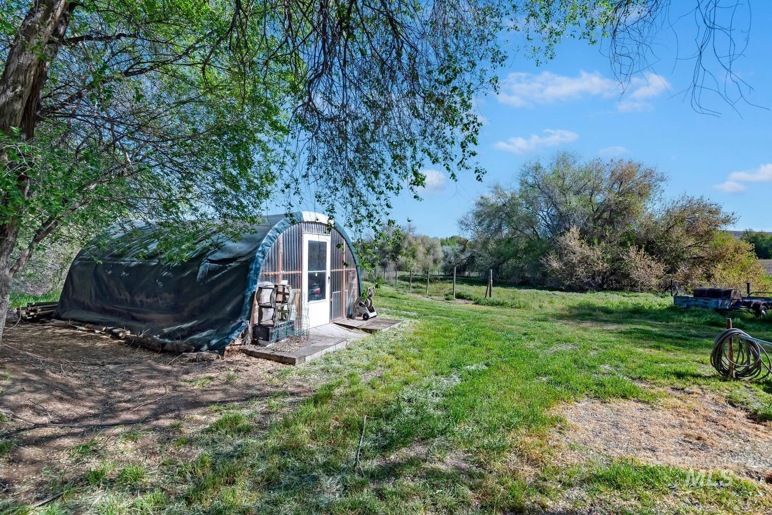 19152 Marsing Road Caldwell, ID 83607 - Photo 11 of 47 Agricultural hoop house featuring a clear end wall with an entry door