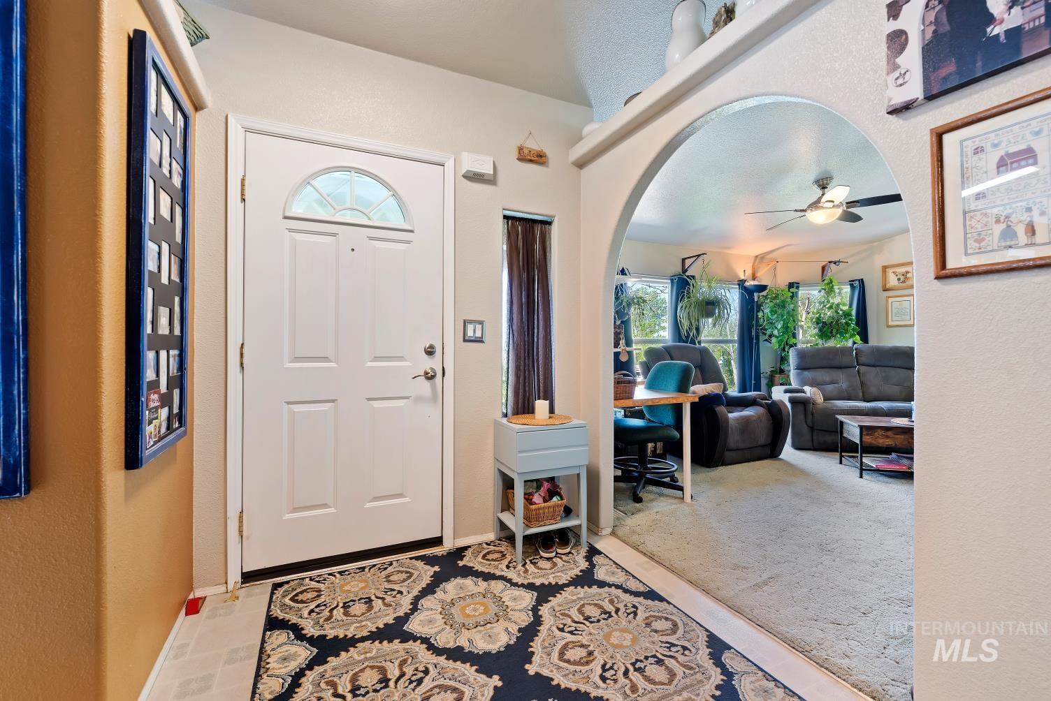19152 Marsing Road Caldwell, ID 83607 - Photo 13 of 47 Entryway featuring a white paneled door with a decorative half-moon window
