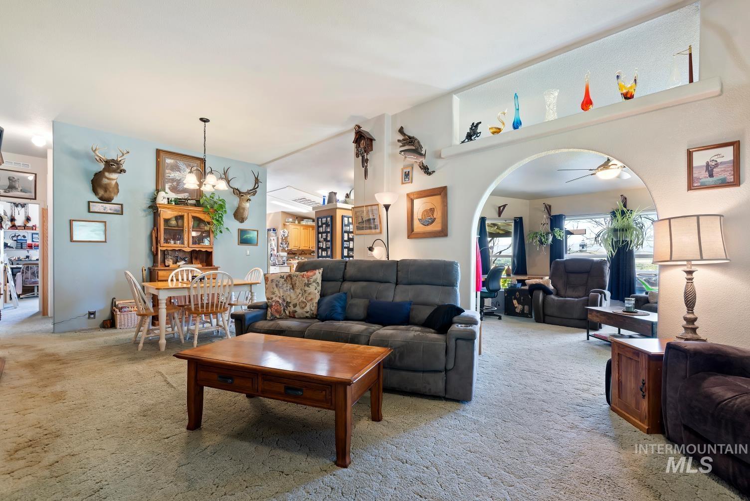 19152 Marsing Road Caldwell, ID 83607 - Photo 16 of 47 Open-concept living space featuring an arched doorway and built-in display shelving