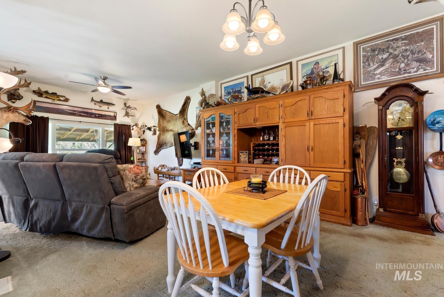 19152 Marsing Road Caldwell, ID 83607 - Photo 17 of 47 Dining area featuring a wood-finish table with four chairs and an overhead chandelier