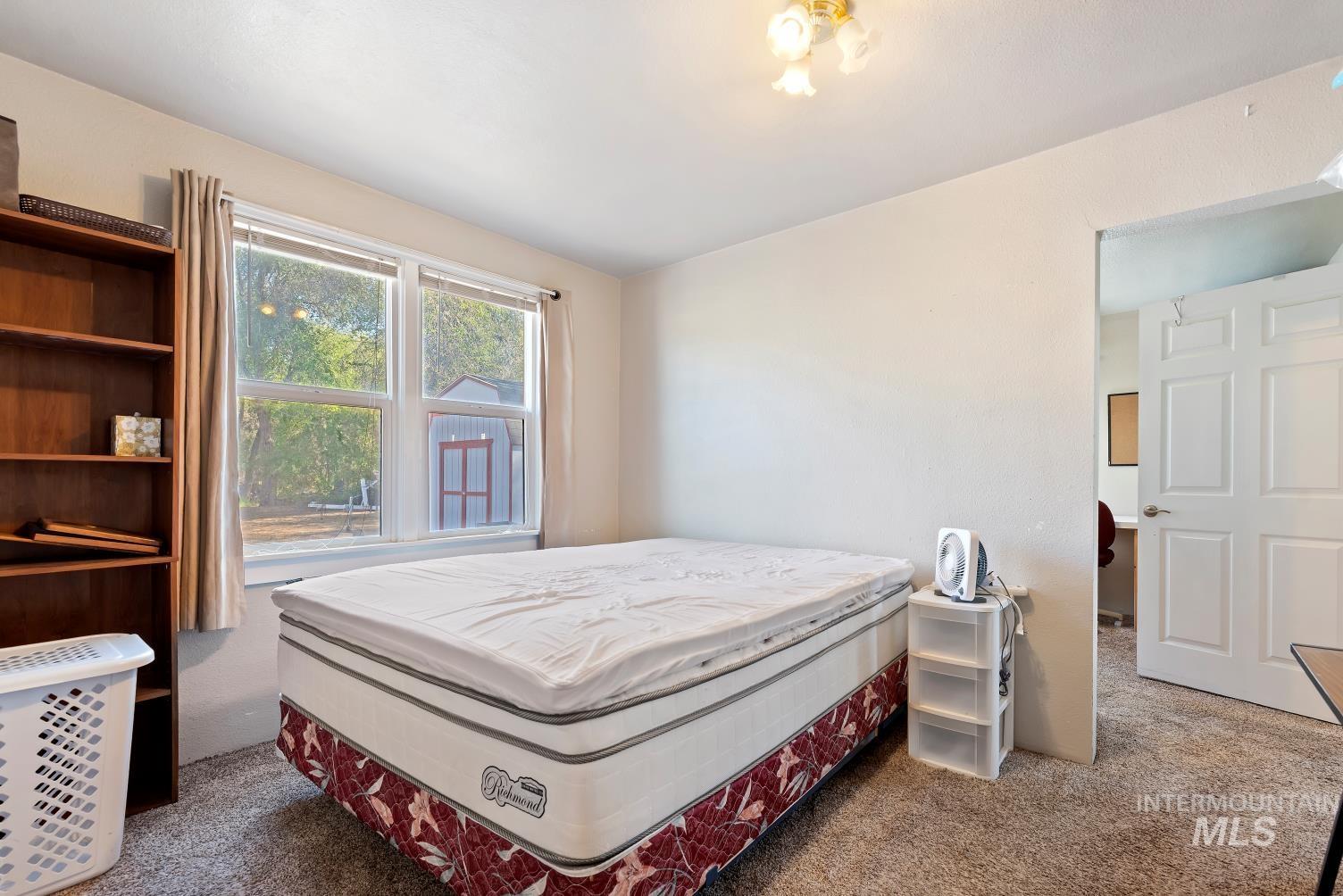 19152 Marsing Road Caldwell, ID 83607 - Photo 45 of 47 Carpeted room featuring a double window, overhead lighting, and a white paneled door