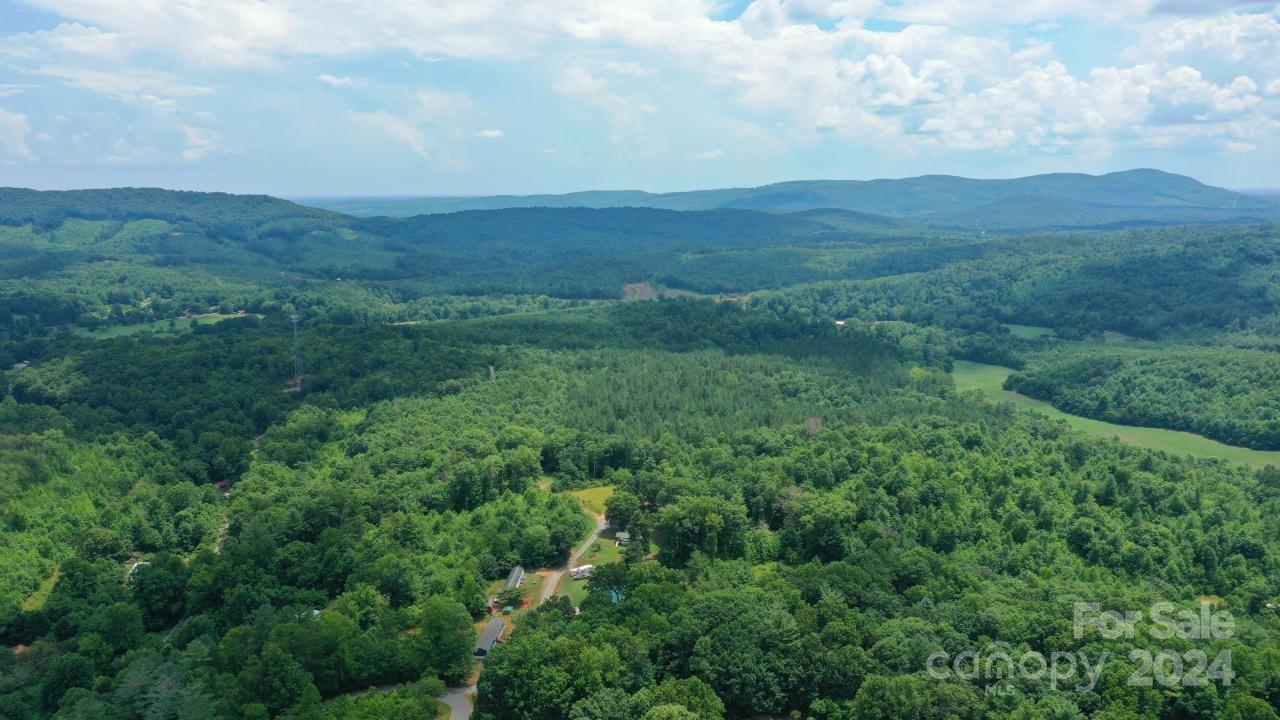 0 Hunt Road Bostic, NC 28018 - Photo 8 of 14 a view of a lush green hillside and a houses