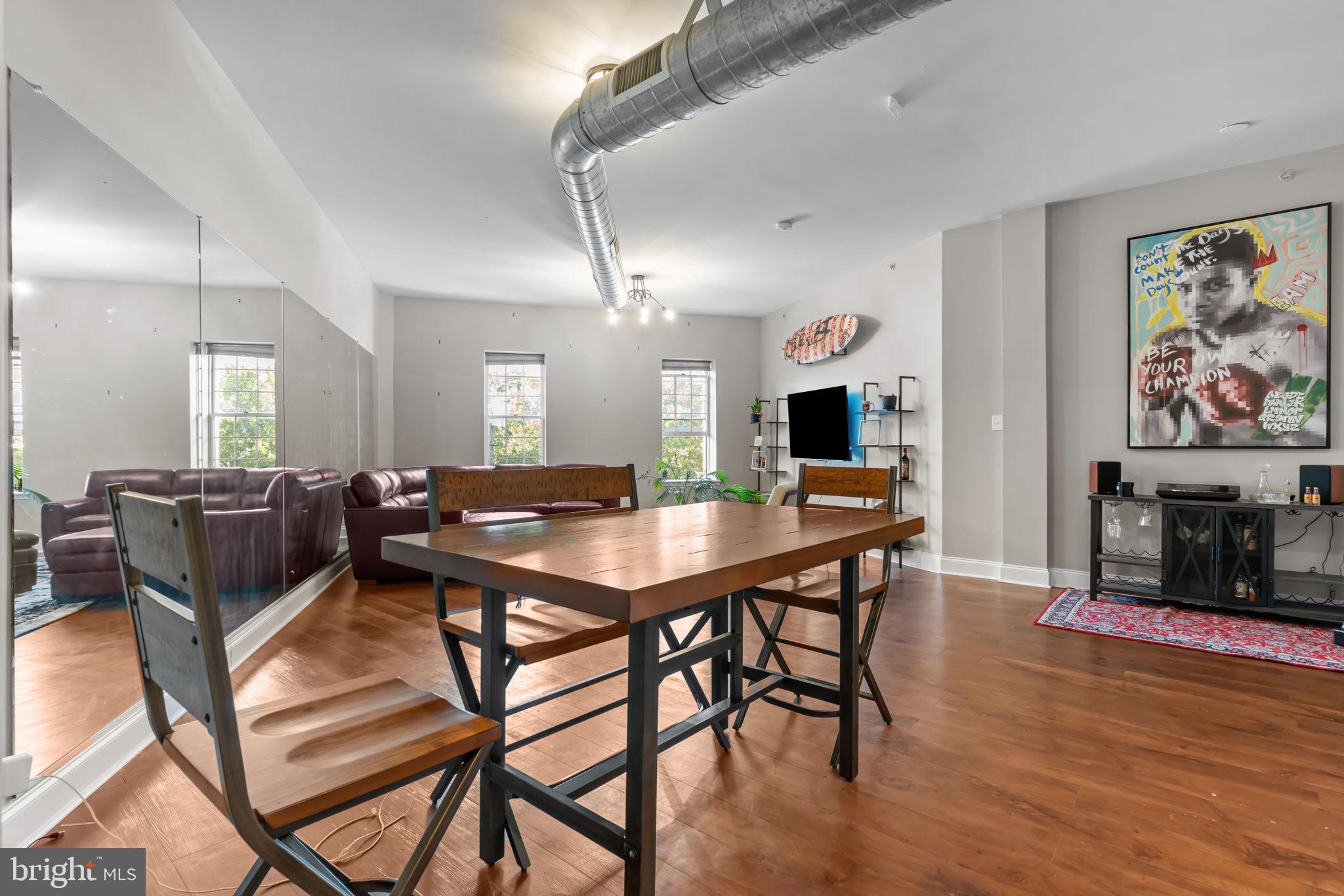 a view of a dining room with furniture a kitchen and chandelier