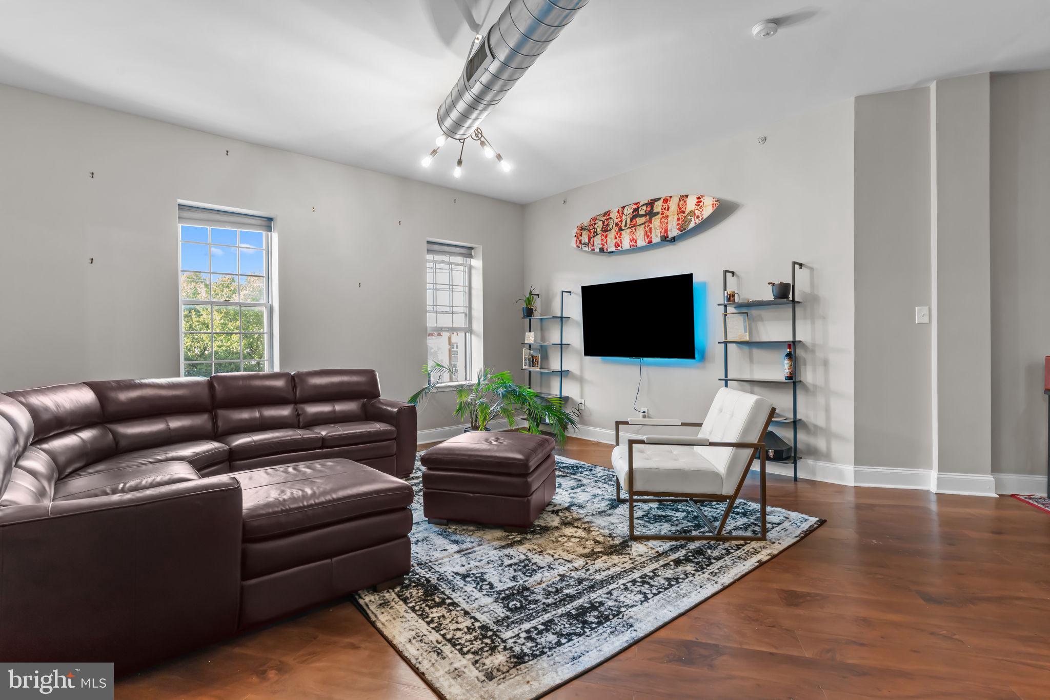 1801 East Passyunk Avenue, Unit B Philadelphia, PA 19148 - Photo 6 of 16 a living room with furniture and a flat screen tv