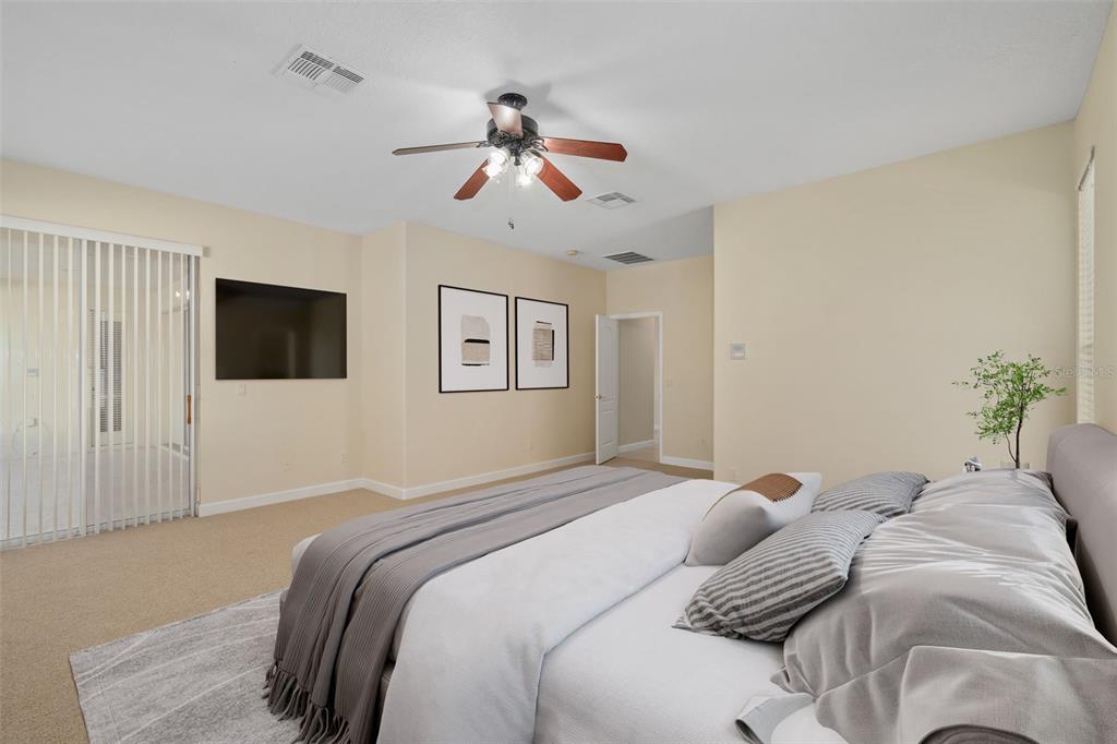 857 Timber Isle Drive Orlando, FL 32828 - Photo 11 of 54 a bedroom with a large bed and a flat screen tv