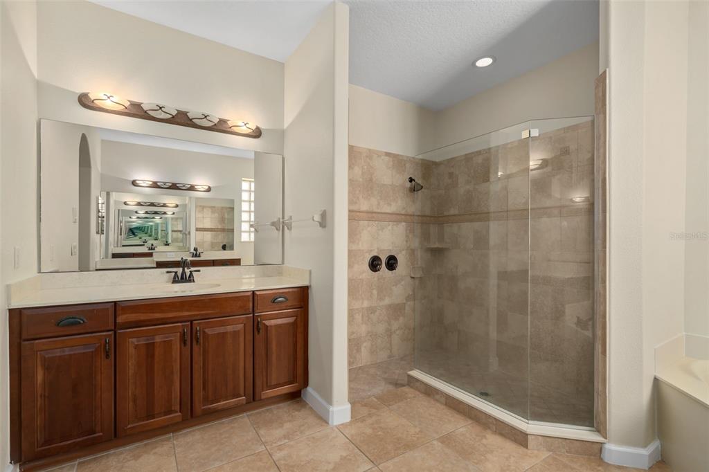 857 Timber Isle Drive Orlando, FL 32828 - Photo 15 of 54 a bathroom with a shower sink and mirror