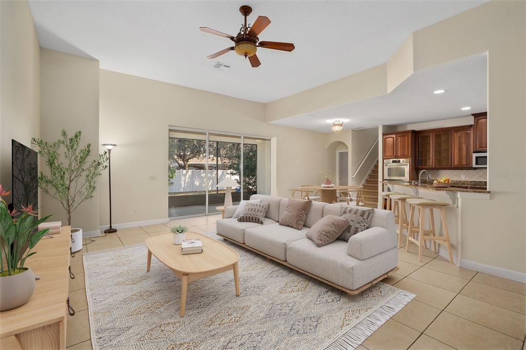 857 Timber Isle Drive Orlando, FL 32828 - Photo 20 of 54 a living room with furniture kitchen view and a potted plant