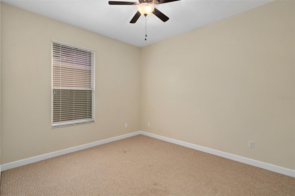 857 Timber Isle Drive Orlando, FL 32828 - Photo 25 of 54 an empty room with a window and a ceiling fan