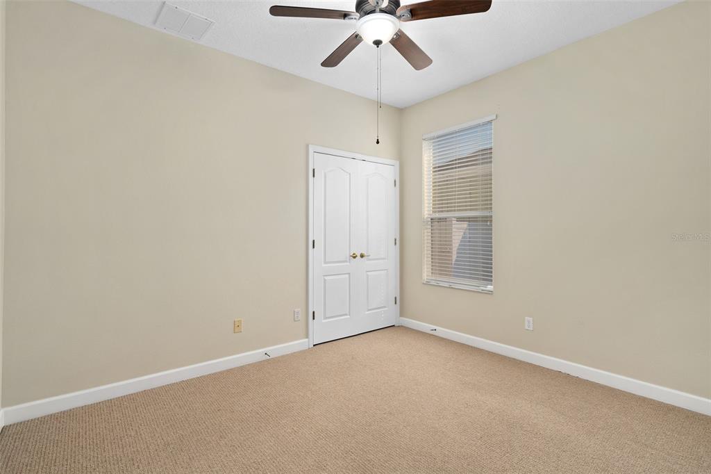 857 Timber Isle Drive Orlando, FL 32828 - Photo 28 of 54 an empty room with chandelier fan and windows