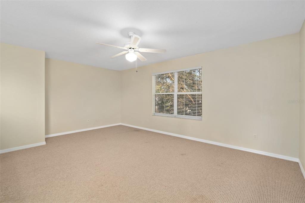 857 Timber Isle Drive Orlando, FL 32828 - Photo 30 of 54 an empty room with windows and fan