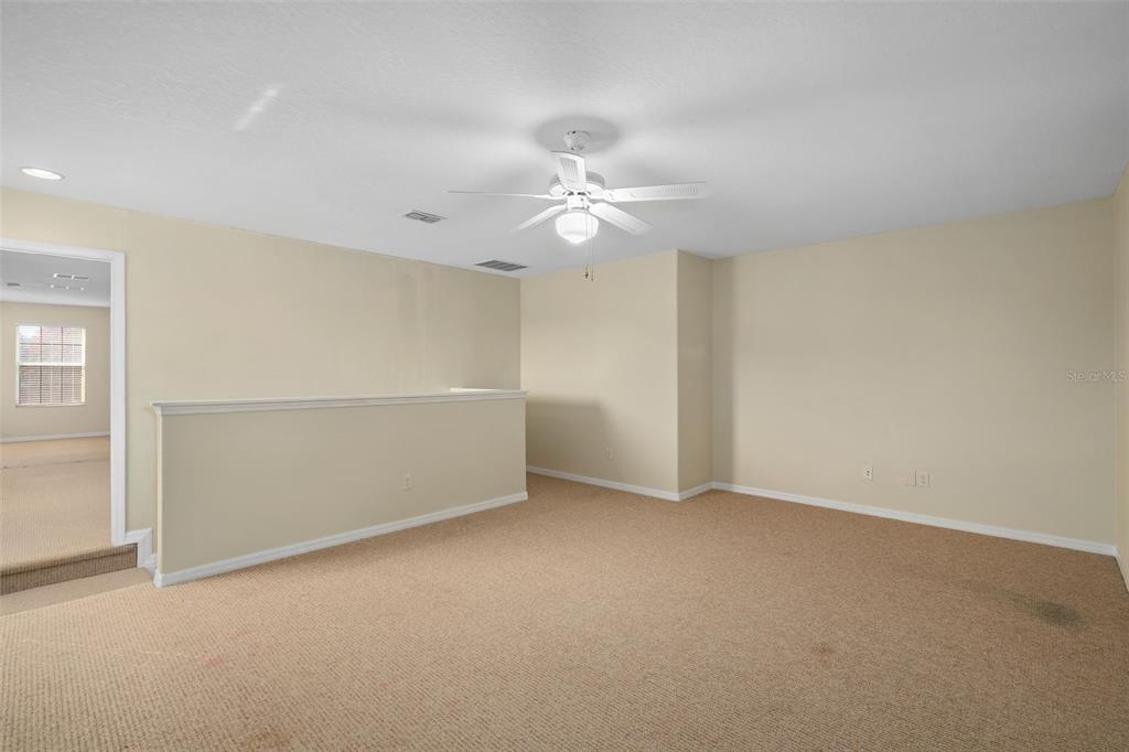 857 Timber Isle Drive Orlando, FL 32828 - Photo 31 of 54 an empty room with a ceiling fan and a window