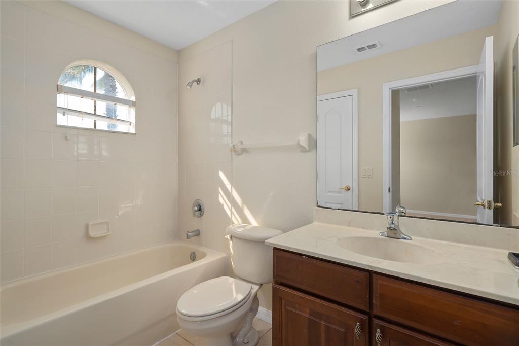 857 Timber Isle Drive Orlando, FL 32828 - Photo 35 of 54 a bathroom with a sink toilet a mirror and shower