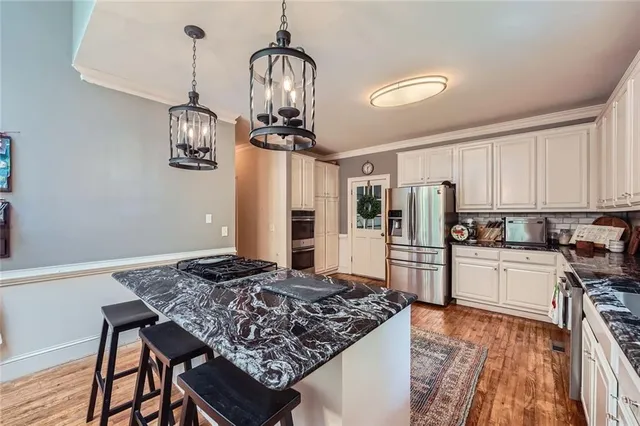 a kitchen with a table and chairs in it