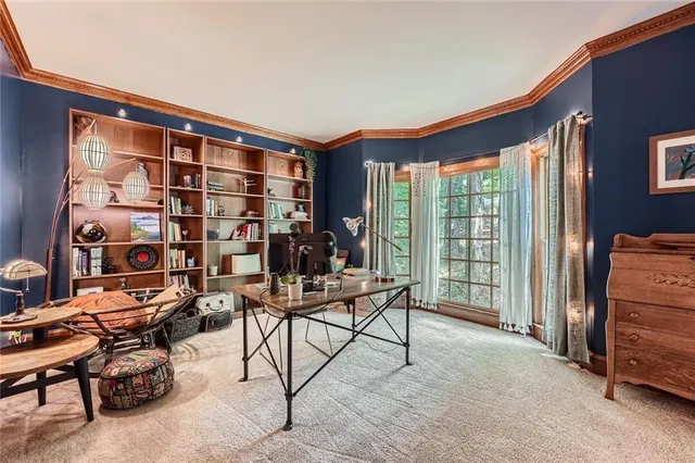 a reading room with furniture and a floor to ceiling window