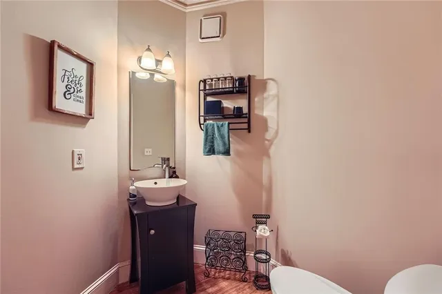 a bathroom with a toilet a sink and mirror