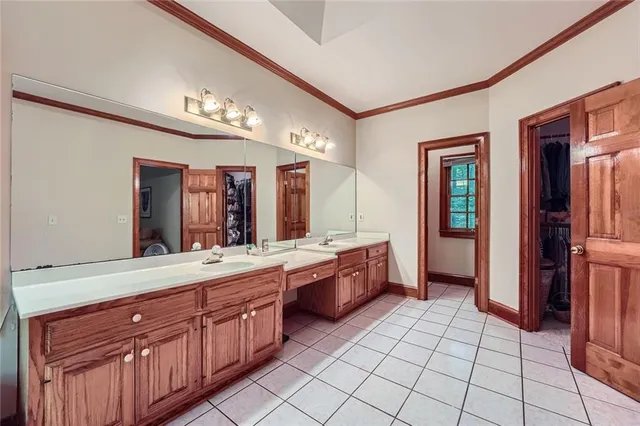 a large bathroom with a large mirror vanity and sink