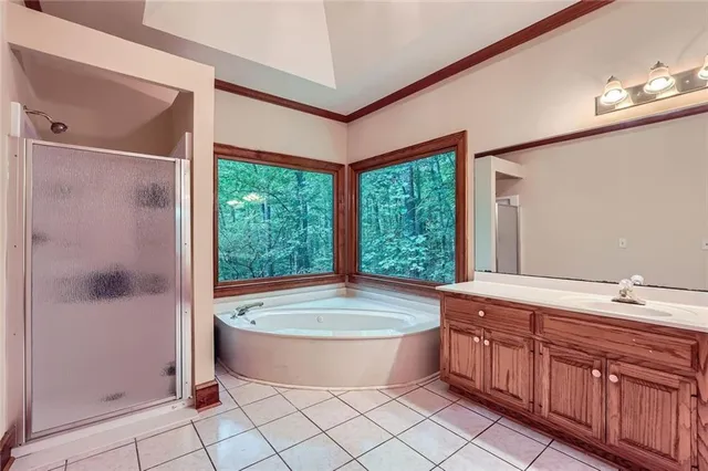 a spacious bathroom with a tub shower and sink