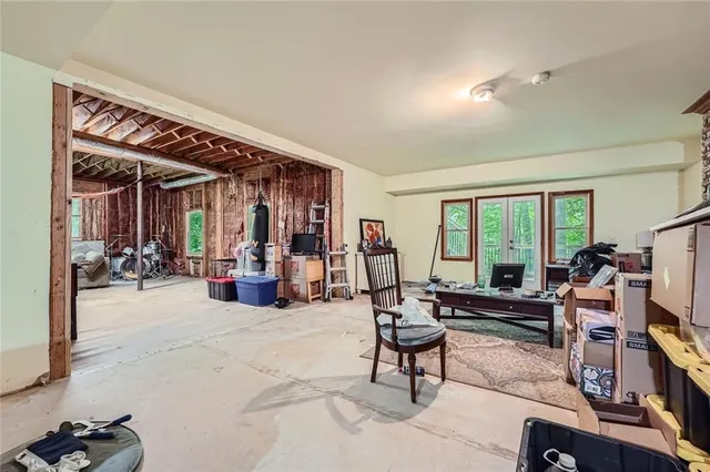 a view of a livingroom with workspace and a window