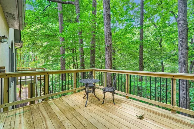 a view of balcony with wooden floor and fence