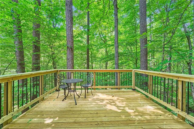 a view of balcony with a floor to ceiling window and wooden fence