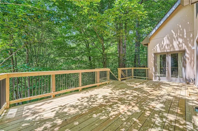 a view of a house with a wooden deck