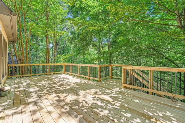 a view of a deck with two chairs and a yard