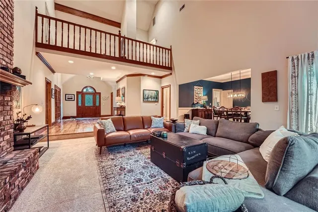 a living room with furniture a couch and a chandelier