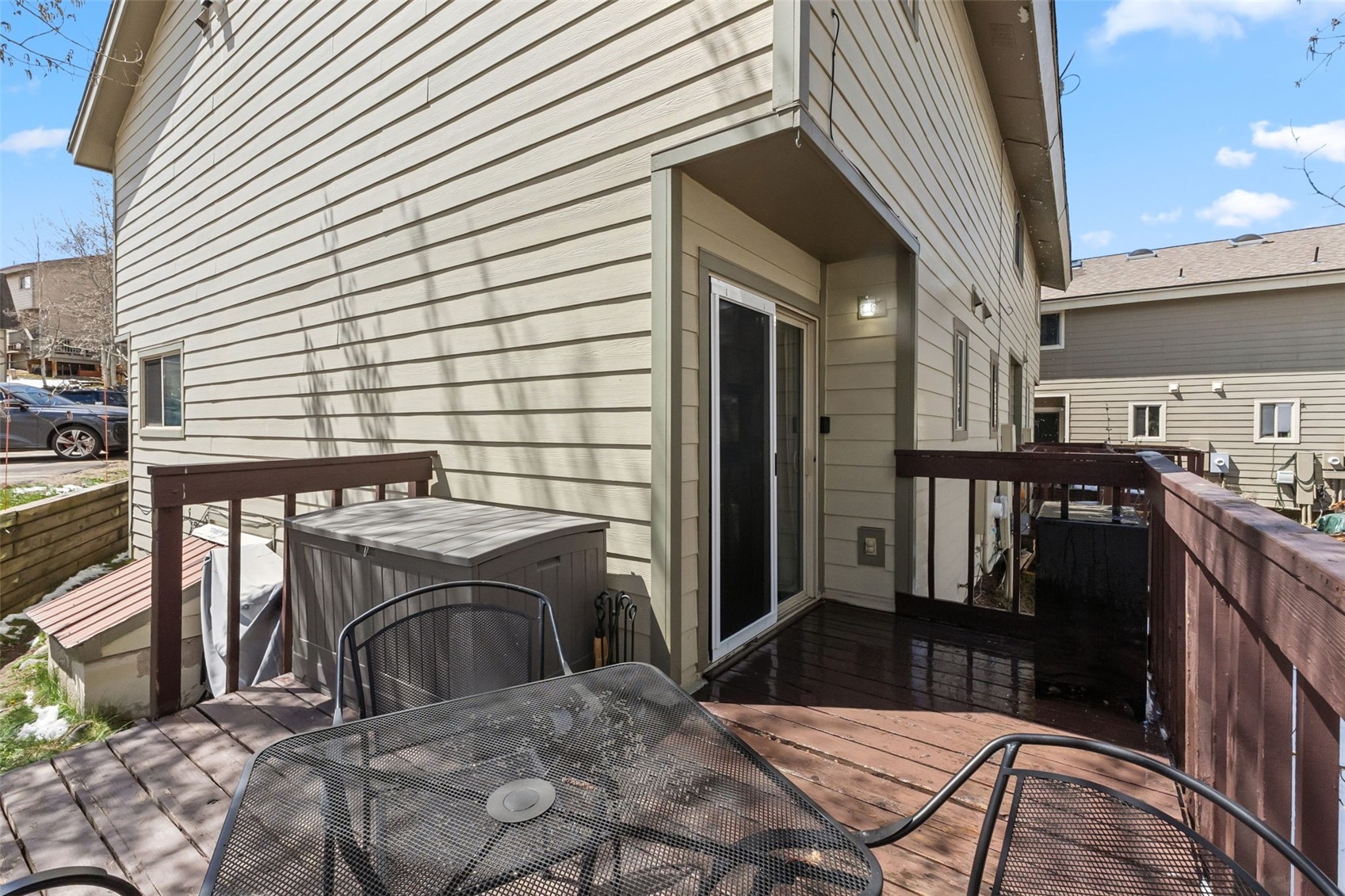 6920 Ryan Gulch Road, Unit 6920 Silverthorne, CO 80498 - Photo 37 of 48 a view of a patio with table and chairs with wooden floor and fence