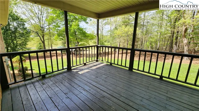 an aerial view of residential house with outdoor space and trees all around