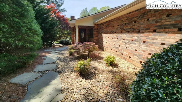 an aerial view of residential house with yard