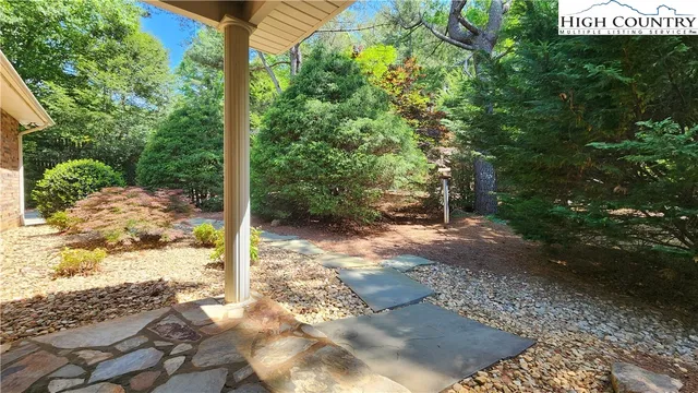 a dining room with furniture a chandelier and wooden floor