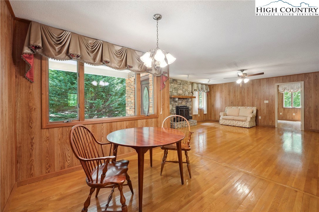 2076 Jay Clark Road Morganton, NC 28655 - Photo 20 of 36 a dining room with furniture a chandelier and wooden floor