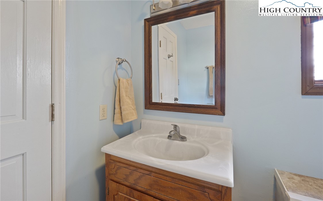 2076 Jay Clark Road Morganton, NC 28655 - Photo 28 of 36 a bathroom with a sink vanity and mirror