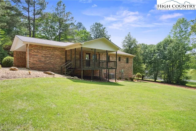 an aerial view of a house with yard