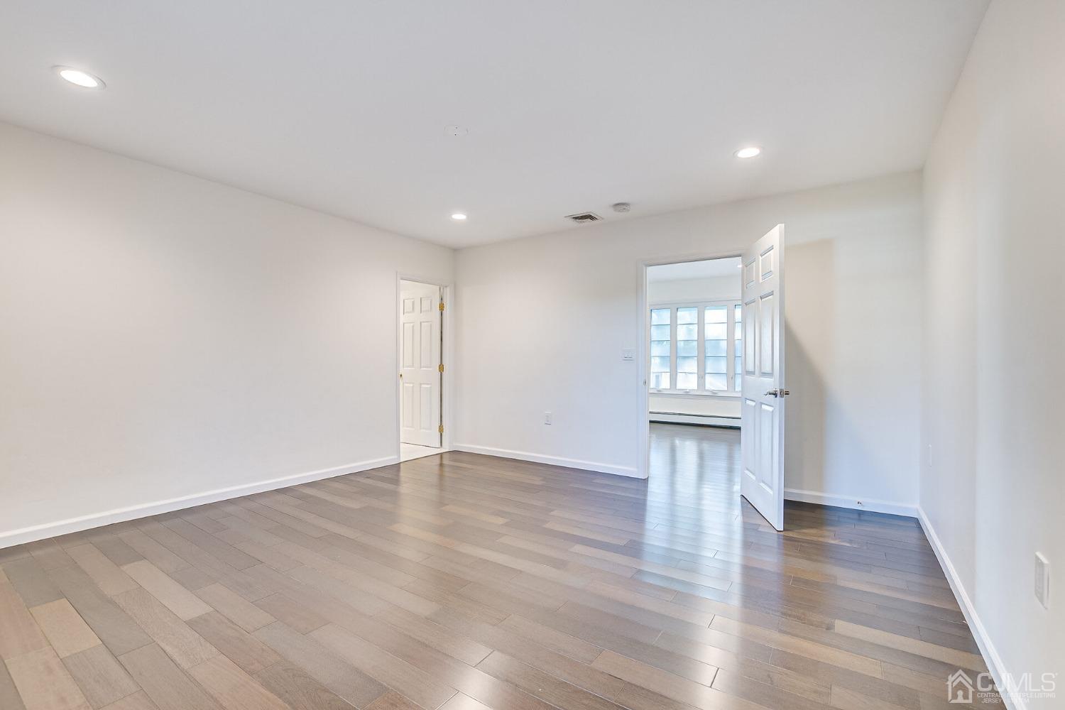 38 New Brooklyn Road Edison, NJ 08817 - Photo 23 of 39 a view of an empty room with wooden floor and a window
