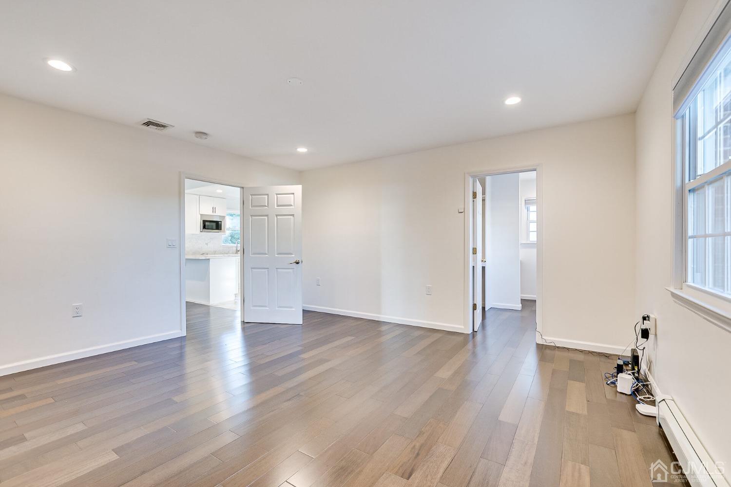 38 New Brooklyn Road Edison, NJ 08817 - Photo 24 of 39 a view of an empty room with wooden floor and a window