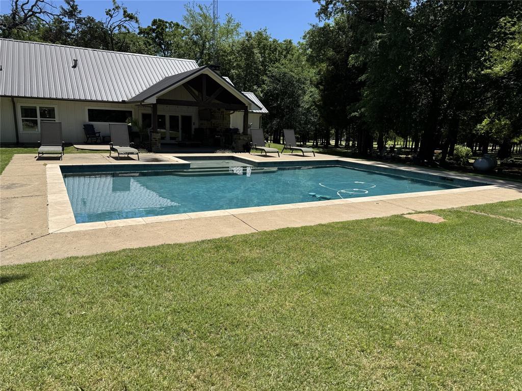 323 County Road 2103 Canton, TX 75103 - Photo 17 of 23 a view of swimming pool with outdoor seating and house in the background