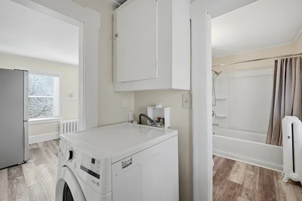 a utility room with cabinets washer and dryer