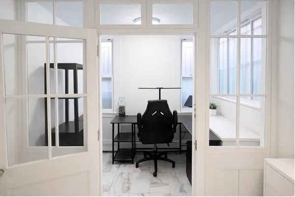 a view of a workspace with furniture and entryway