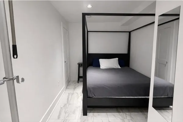 a bedroom with a bed and a mirror