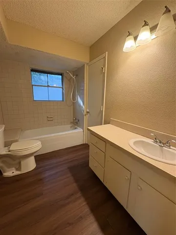 a bathroom with a bathtub and a toilet